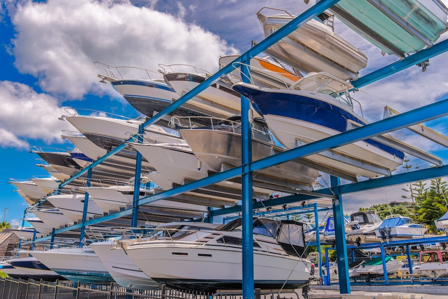boats stored on an outdoor rack in a marina