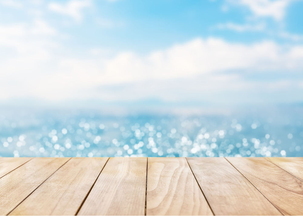 Wooden deck with a view of the ocean and blue sky
